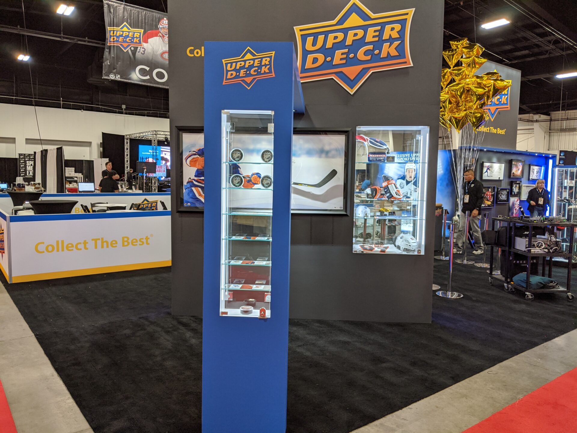 Upper Deck trade show booth with glass exhibits and memorabilia