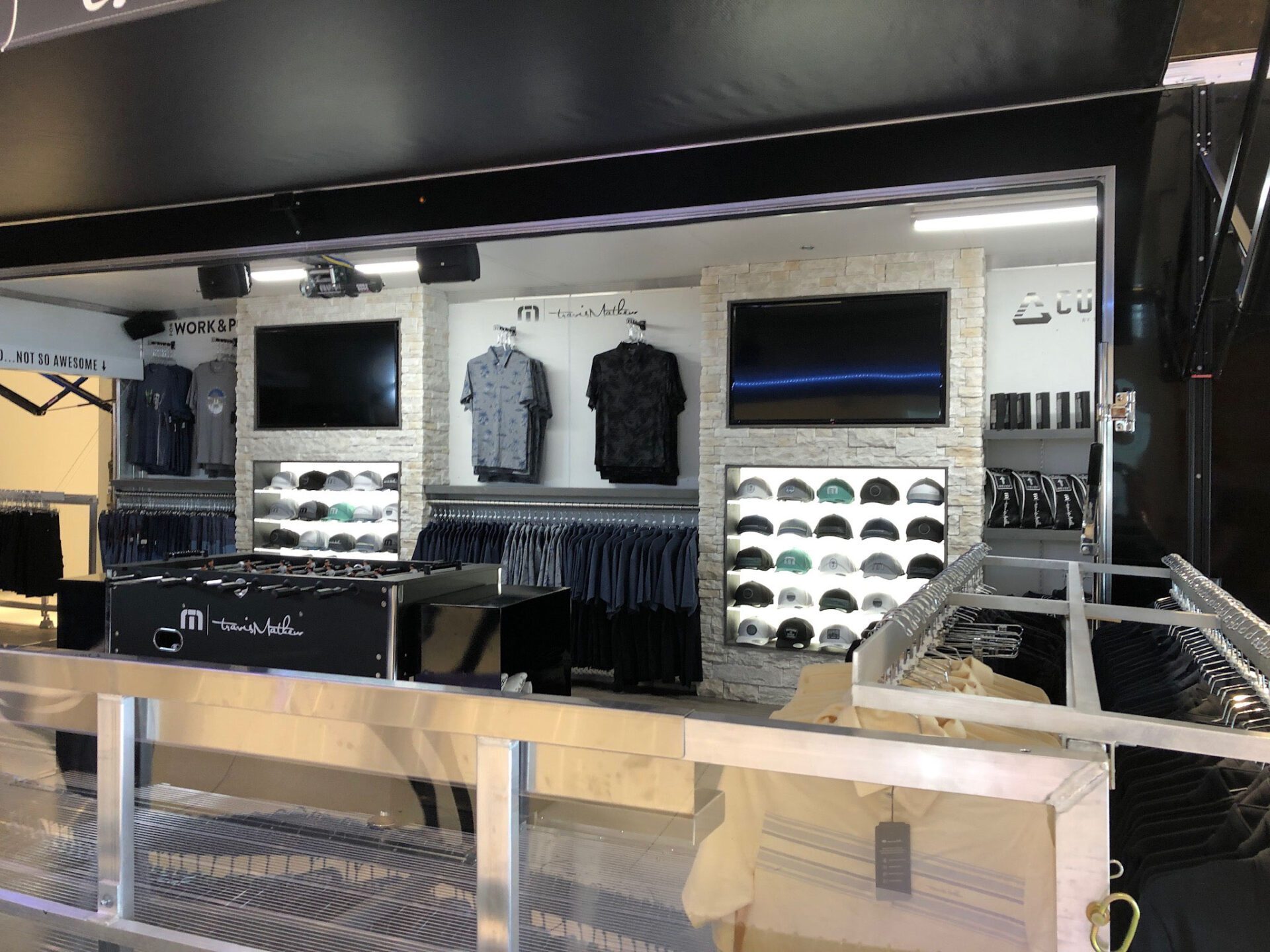 Travis Mathew mobile showroom with hats, shirts and other merchandise
