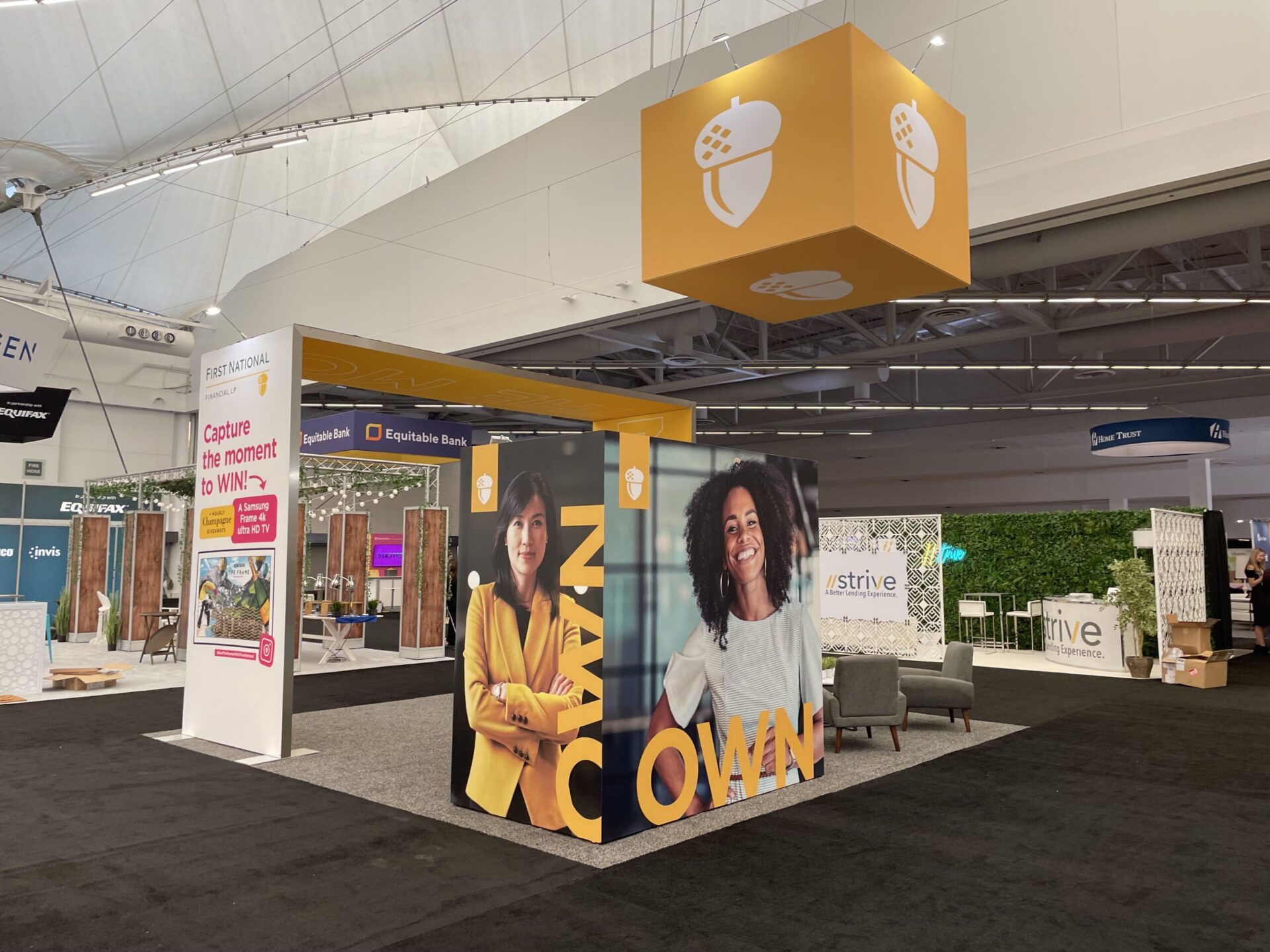 First National bank trade show booth with large photos of customers