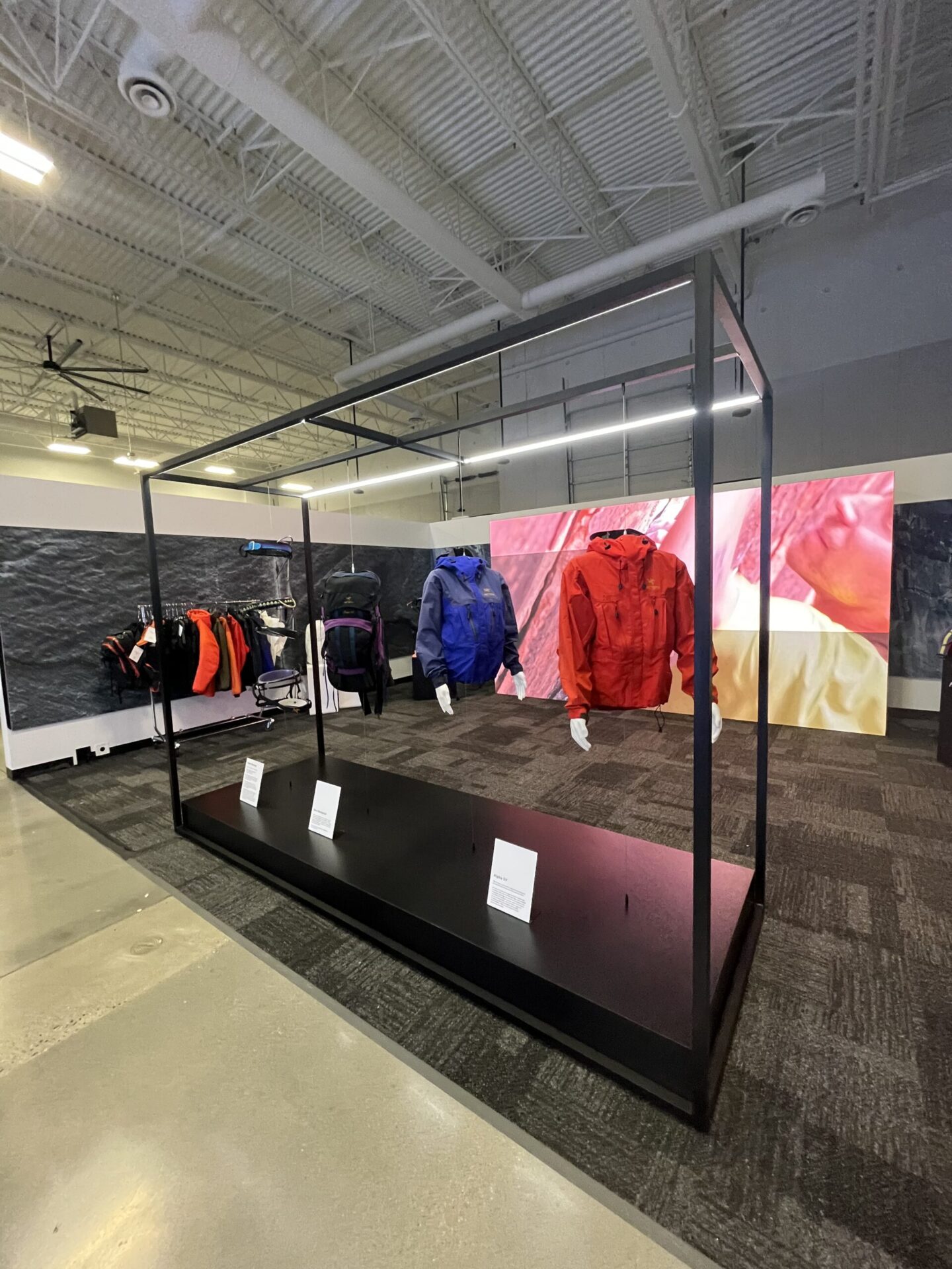 Arc'teryx trade show booth with glass product showcase