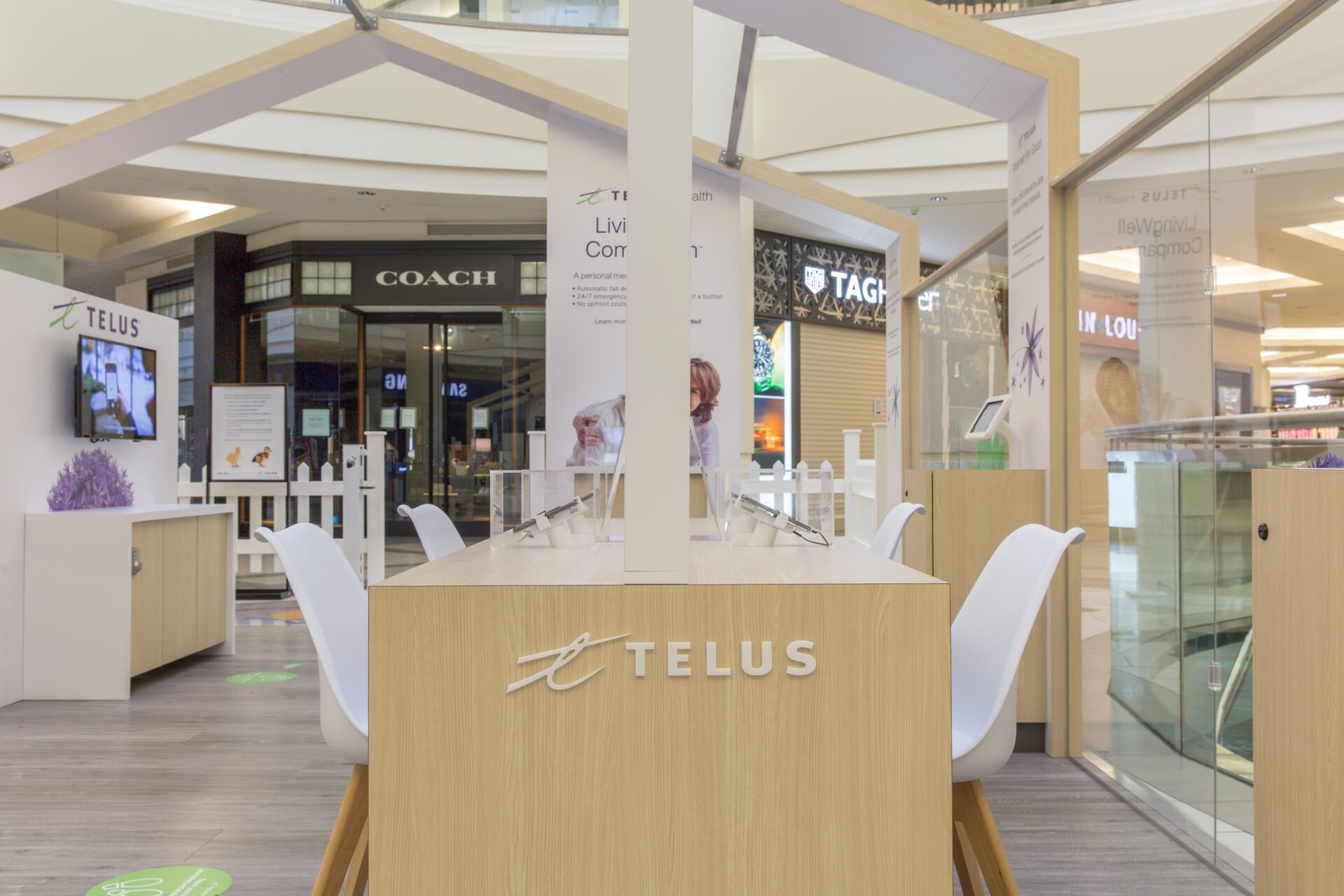 Telus wooden permanent mall display from front with focus on counter