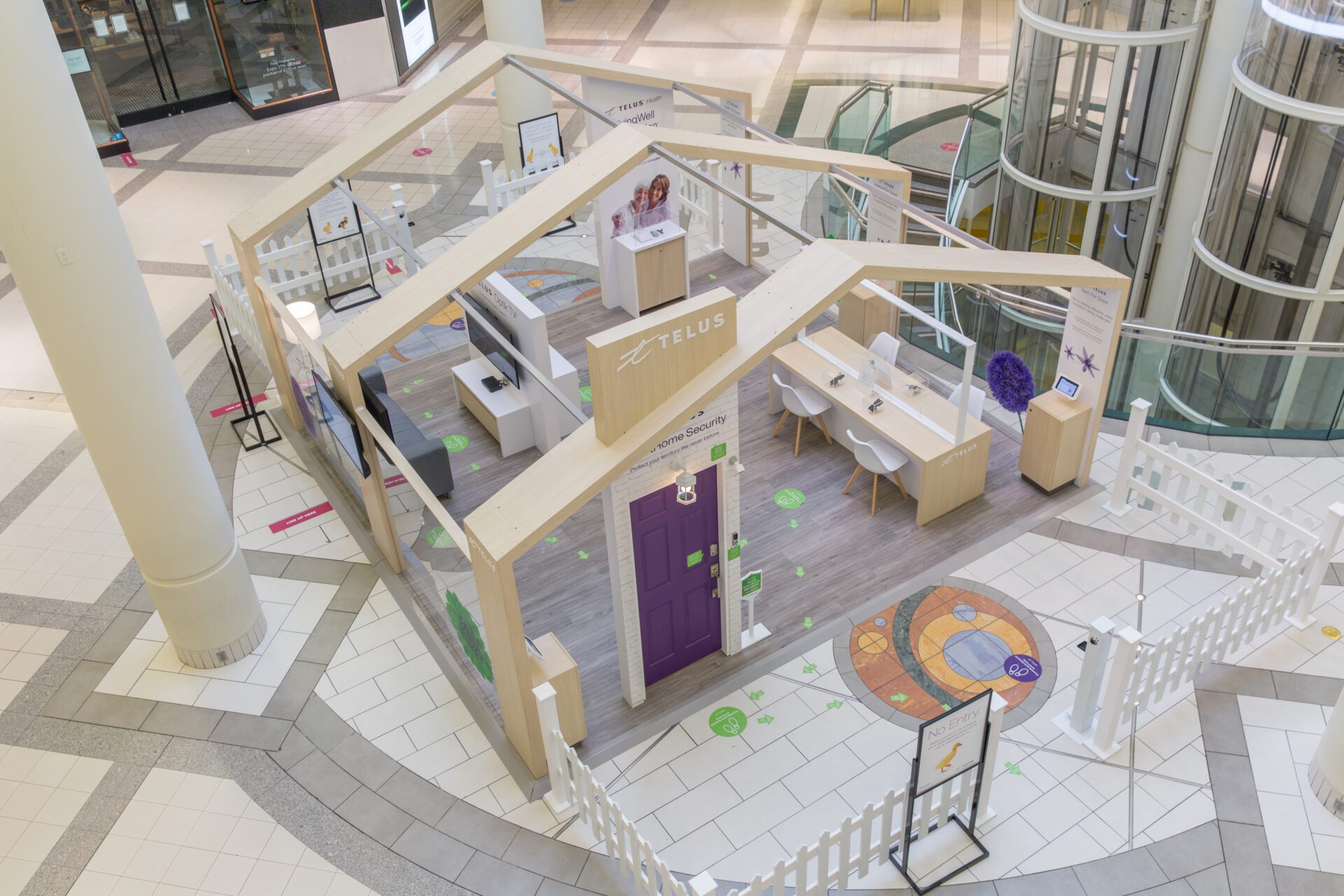 Telus wooden permanent mall display with purple door from overhead