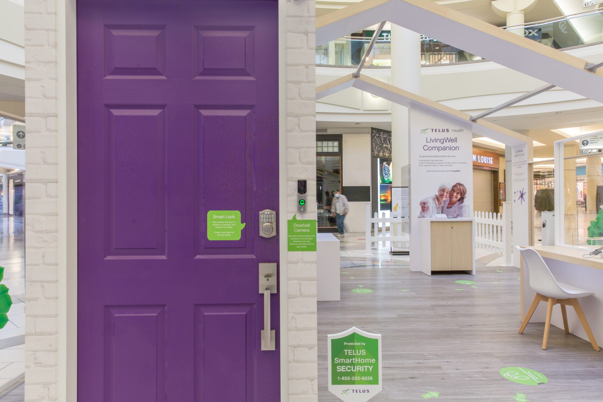 Telus wooden permanent mall display from front with focus on purple door