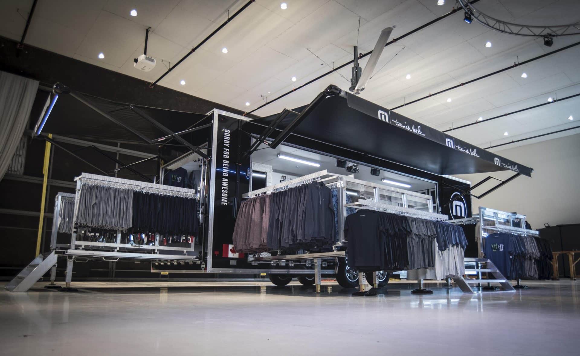 Travis Mathew mobile showroom with hats, shirts and other merchandise