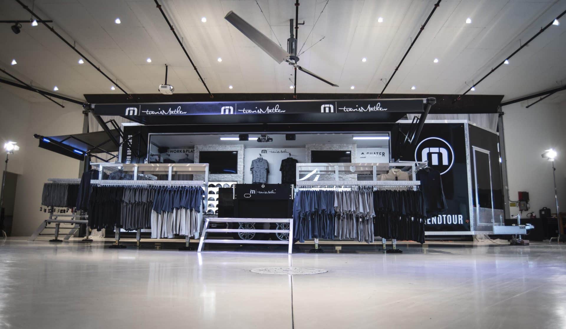 Travis Mathew mobile showroom with hats, shirts and other merchandise