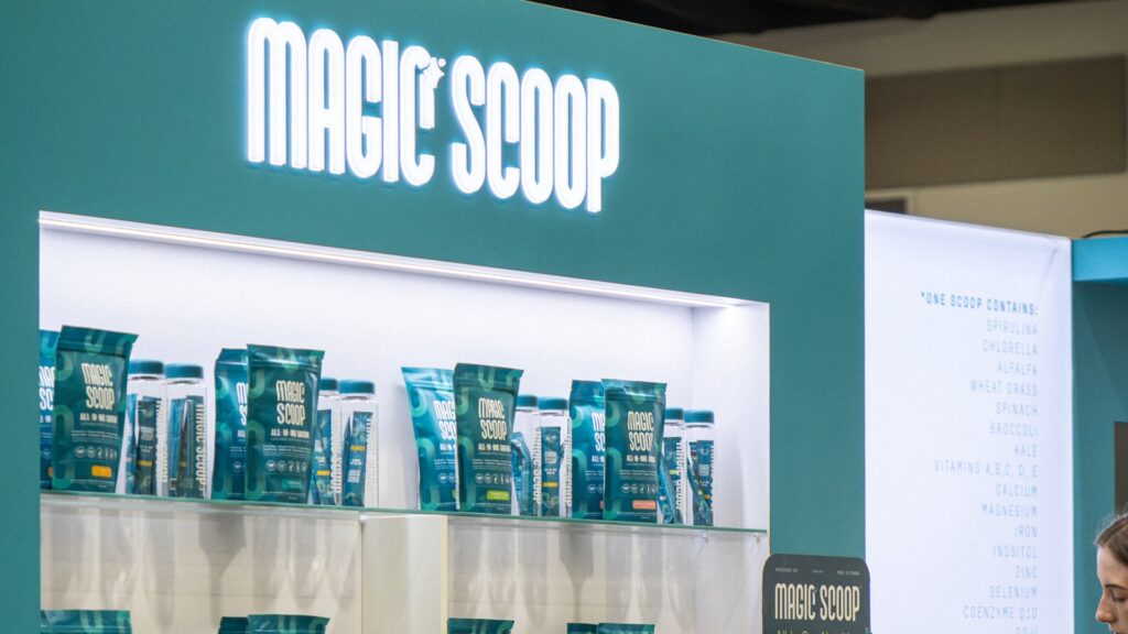 Magic Scoop CHFA trade show booth product wall with staff engagement