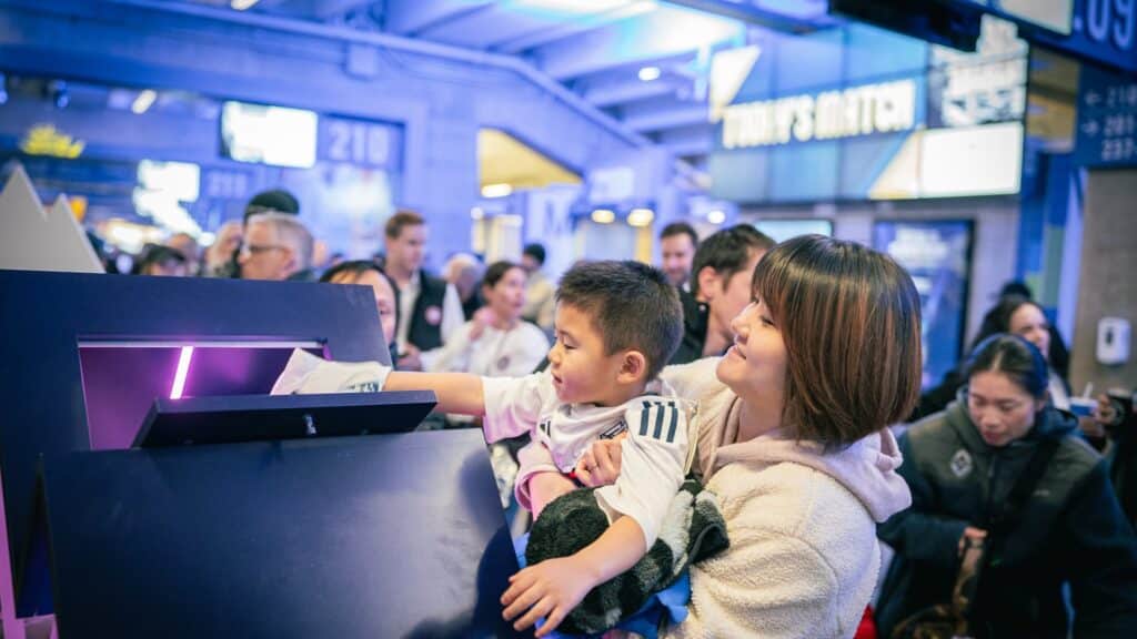 TELUS mobile tour activation at BC Place with family engaging at interactive station